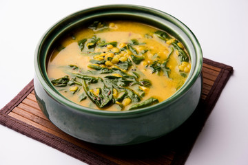 Dal Palak or Lentil spinach curry - popular Indian main course healthy recipe. served in a karahi/pan or bowl. selective focus