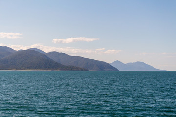 A blue tropical sky meets the ocean
