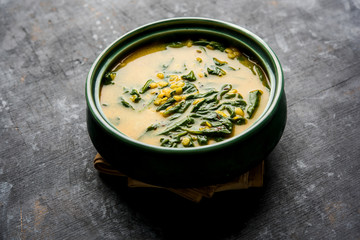 Dal Palak or Lentil spinach curry - popular Indian main course healthy recipe. served in a karahi/pan or bowl. selective focus