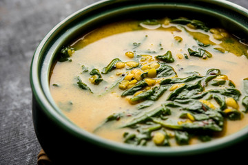 Dal Palak or Lentil spinach curry - popular Indian main course healthy recipe. served in a karahi/pan or bowl. selective focus
