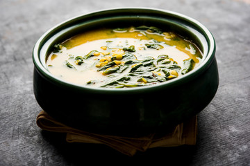 Dal Palak or Lentil spinach curry - popular Indian main course healthy recipe. served in a karahi/pan or bowl. selective focus