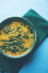 Dal Palak or Lentil spinach curry - popular Indian main course healthy recipe. served in a karahi/pan or bowl. selective focus