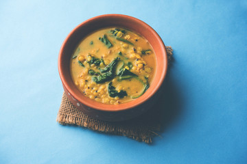 Dal Palak or Lentil spinach curry - popular Indian main course healthy recipe. served in a karahi/pan or bowl. selective focus