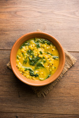 Dal Palak or Lentil spinach curry - popular Indian main course healthy recipe. served in a karahi/pan or bowl. selective focus