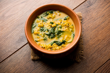 Dal Palak or Lentil spinach curry - popular Indian main course healthy recipe. served in a karahi/pan or bowl. selective focus