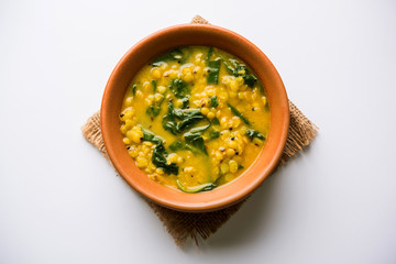 Dal Palak or Lentil spinach curry - popular Indian main course healthy recipe. served in a...