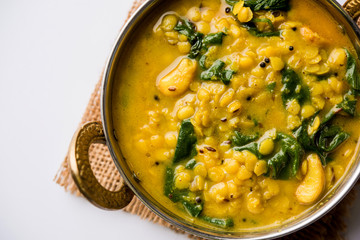 Dal Palak or Lentil spinach curry - popular Indian main course healthy recipe. served in a...