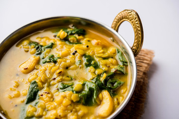 Dal Palak or Lentil spinach curry - popular Indian main course healthy recipe. served in a karahi/pan or bowl. selective focus