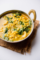 Dal Palak or Lentil spinach curry - popular Indian main course healthy recipe. served in a karahi/pan or bowl. selective focus
