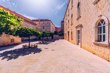 Narrow street in historic town Trogir, Croatia. Travel destination. Narrow old street in Trogir city, Croatia. The alleys of the old town of Trogir are very picturesque and full of charm. Croatia.