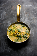 Dal Palak or Lentil spinach curry - popular Indian main course healthy recipe. served in a karahi/pan or bowl. selective focus
