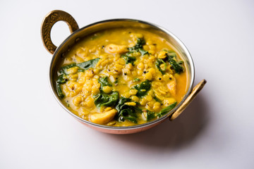 Dal Palak or Lentil spinach curry - popular Indian main course healthy recipe. served in a karahi/pan or bowl. selective focus