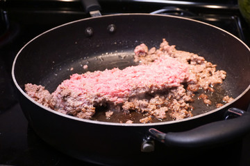 Ground beef cooking in frying pan