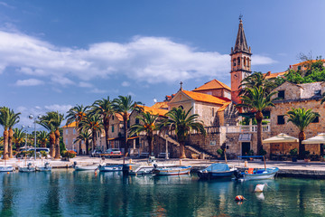 Fototapeta premium Fishing boats in Splitska village with beautiful port, Brac island, Croatia. Village of Splitska on Brac island seafront view, Dalmatia, Croatia, Croatia.