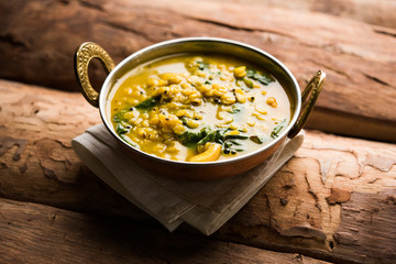 Dal Palak or Lentil spinach curry - popular Indian main course healthy recipe. served in a karahi/pan or bowl. selective focus