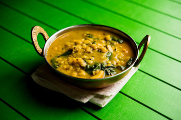 Dal Palak or Lentil spinach curry - popular Indian main course healthy recipe. served in a karahi/pan or bowl. selective focus
