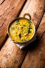 Dal Palak or Lentil spinach curry - popular Indian main course healthy recipe. served in a karahi/pan or bowl. selective focus