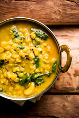 Dal Palak or Lentil spinach curry - popular Indian main course healthy recipe. served in a karahi/pan or bowl. selective focus
