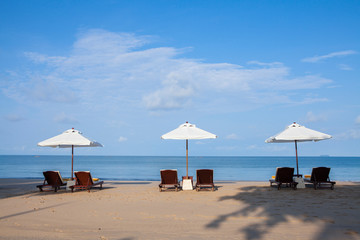 Beach chairs on the white sand beach.