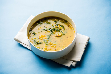 Dal Palak or Lentil spinach curry - popular Indian main course healthy recipe. served in a karahi/pan or bowl. selective focus