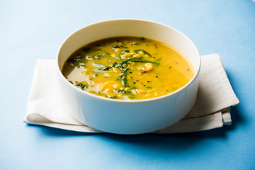 Dal Palak or Lentil spinach curry - popular Indian main course healthy recipe. served in a karahi/pan or bowl. selective focus