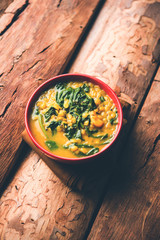 Dal Palak or Lentil spinach curry - popular Indian main course healthy recipe. served in a karahi/pan or bowl. selective focus