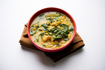 Dal Palak or Lentil spinach curry - popular Indian main course healthy recipe. served in a karahi/pan or bowl. selective focus