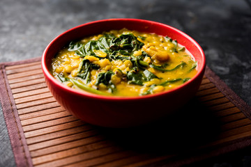 Dal Palak or Lentil spinach curry - popular Indian main course healthy recipe. served in a karahi/pan or bowl. selective focus