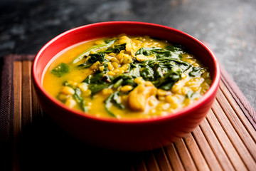 Dal Palak or Lentil spinach curry - popular Indian main course healthy recipe. served in a karahi/pan or bowl. selective focus