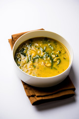 Dal Palak or Lentil spinach curry - popular Indian main course healthy recipe. served in a karahi/pan or bowl. selective focus