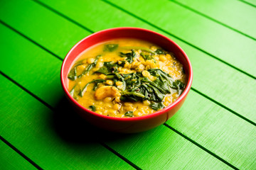 Dal Palak or Lentil spinach curry - popular Indian main course healthy recipe. served in a karahi/pan or bowl. selective focus