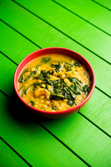 Dal Palak or Lentil spinach curry - popular Indian main course healthy recipe. served in a karahi/pan or bowl. selective focus