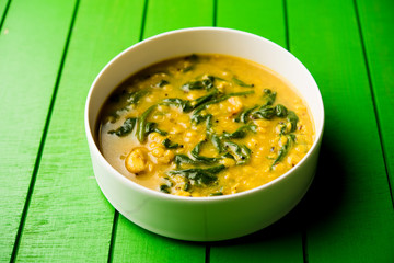 Dal Palak or Lentil spinach curry - popular Indian main course healthy recipe. served in a karahi/pan or bowl. selective focus