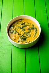 Dal Palak or Lentil spinach curry - popular Indian main course healthy recipe. served in a karahi/pan or bowl. selective focus