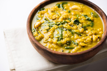 Dal Palak or Lentil spinach curry - popular Indian main course healthy recipe. served in a karahi/pan or bowl. selective focus