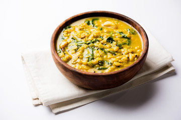 Dal Palak or Lentil spinach curry - popular Indian main course healthy recipe. served in a karahi/pan or bowl. selective focus