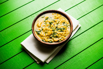 Dal Palak or Lentil spinach curry - popular Indian main course healthy recipe. served in a karahi/pan or bowl. selective focus