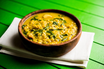 Dal Palak or Lentil spinach curry - popular Indian main course healthy recipe. served in a karahi/pan or bowl. selective focus