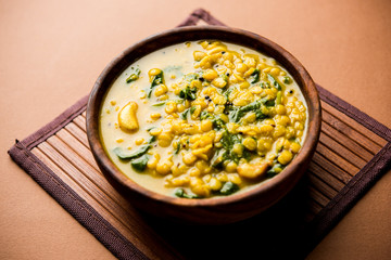 Dal Palak or Lentil spinach curry - popular Indian main course healthy recipe. served in a karahi/pan or bowl. selective focus