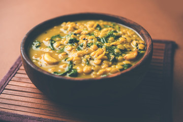 Dal Palak or Lentil spinach curry - popular Indian main course healthy recipe. served in a karahi/pan or bowl. selective focus