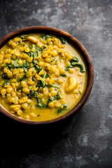 Dal Palak or Lentil spinach curry - popular Indian main course healthy recipe. served in a karahi/pan or bowl. selective focus