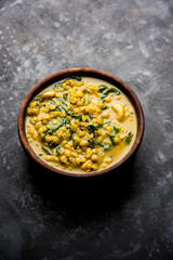 Dal Palak or Lentil spinach curry - popular Indian main course healthy recipe. served in a karahi/pan or bowl. selective focus