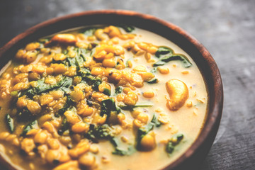 Dal Palak or Lentil spinach curry - popular Indian main course healthy recipe. served in a karahi/pan or bowl. selective focus