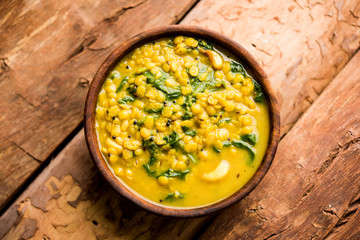 Dal Palak or Lentil spinach curry - popular Indian main course healthy recipe. served in a karahi/pan or bowl. selective focus