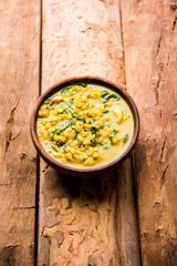 Dal Palak or Lentil spinach curry - popular Indian main course healthy recipe. served in a karahi/pan or bowl. selective focus