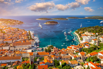 Fototapeta premium Amazing historic town of Hvar aerial view, Dalmatia, Croatia. Island of Hvar bay aerial view, Dalmatia, Croatia. Harbor of old Adriatic island town Hvar. Popular touristic destination of Croatia.