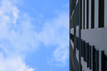 blue sky with white clouds above high building