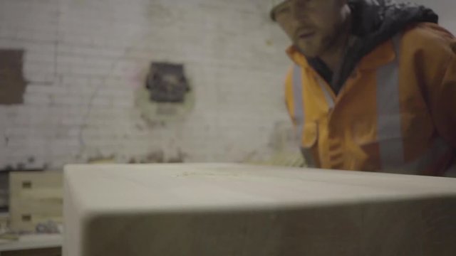 blows dust from finished wood above self employed carpenter wood