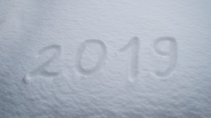abstract winter New Year's and Christmas background from snow.text on snow 2019