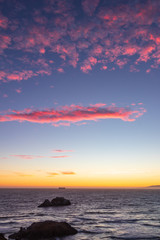 Beautiful sunset on the coast of San Francisco with powdery pink clouds in the sky